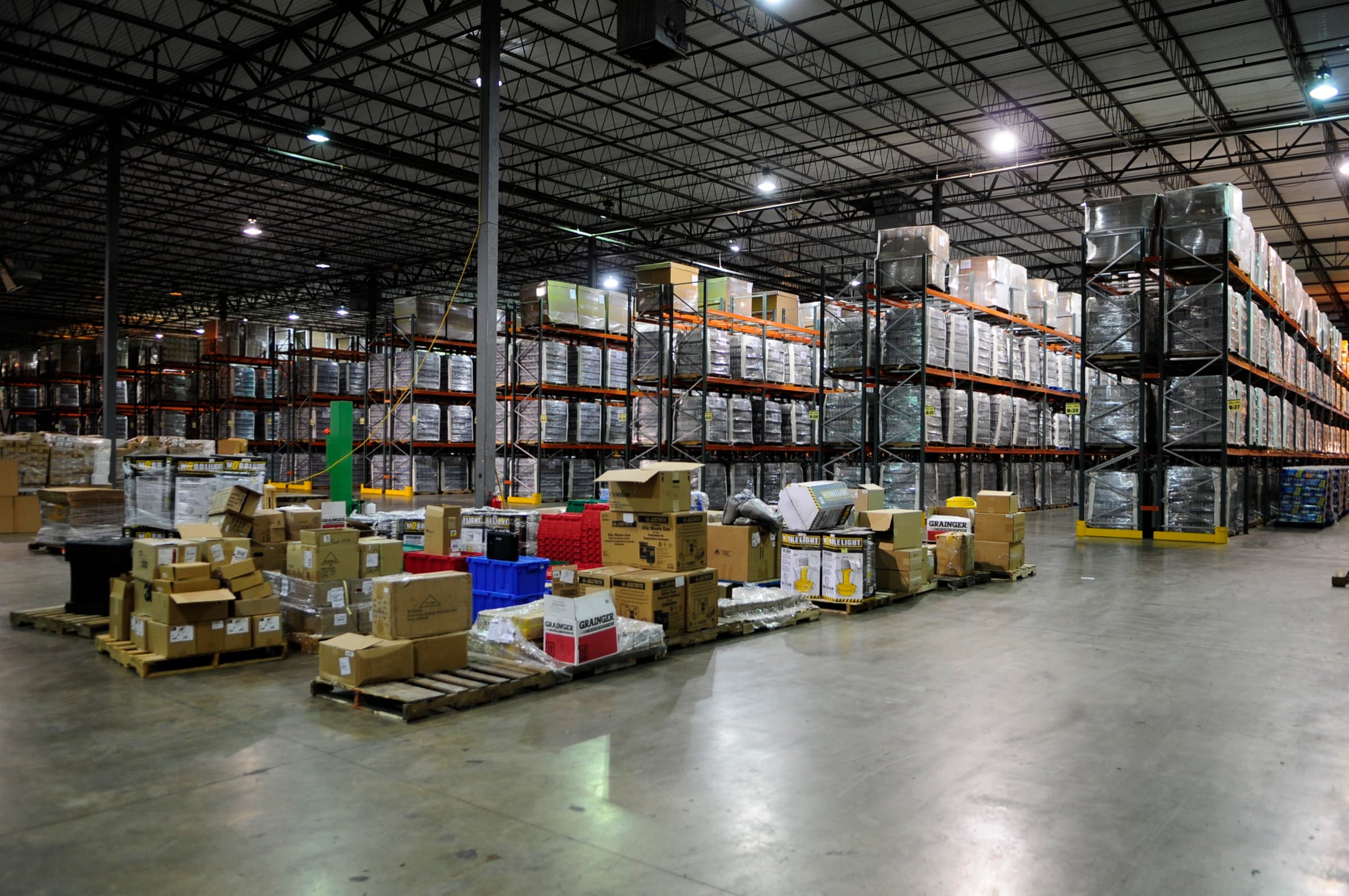 Palletized goods and tall racking inside a logistics warehouse